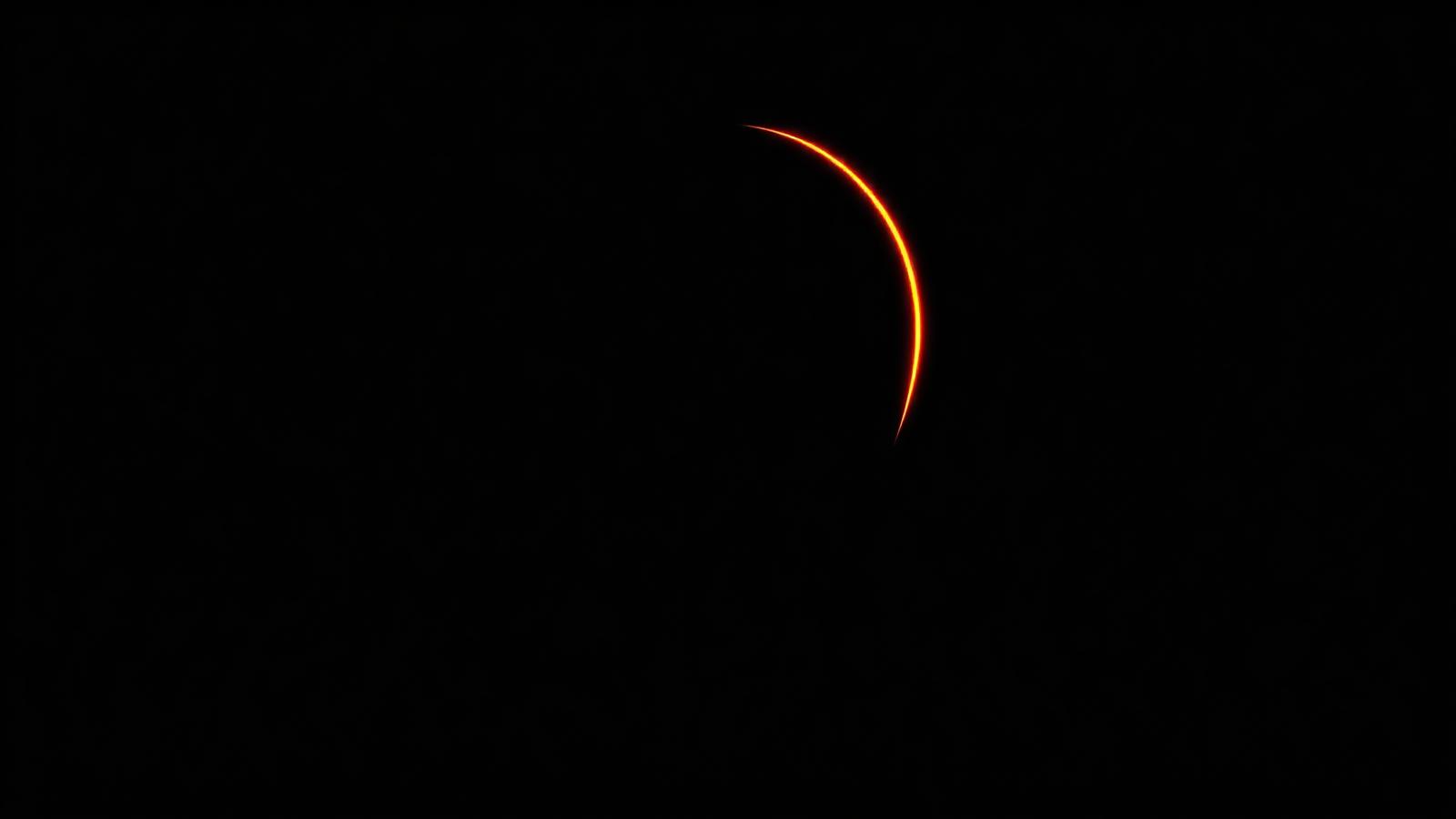A face silhouette outlined by a single ember verification arc