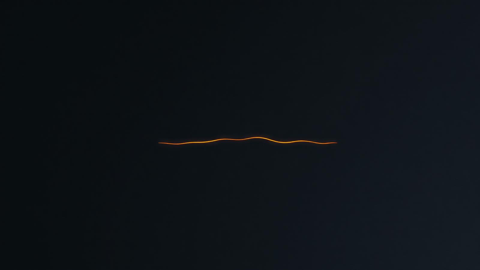 A single ember word on black unfolding into a printed page